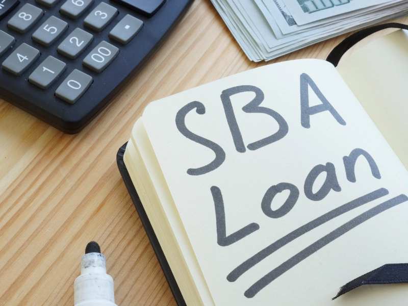 SBA loan written in a notebook. Featured image for “Are SBA Loan Interests Tax Deductible?”