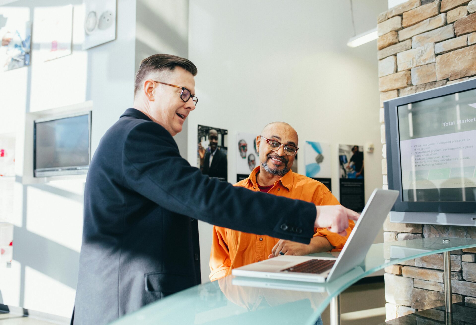 A funding advisor explains alternative business funding solutions to a small business owner in a well-lit workspace.