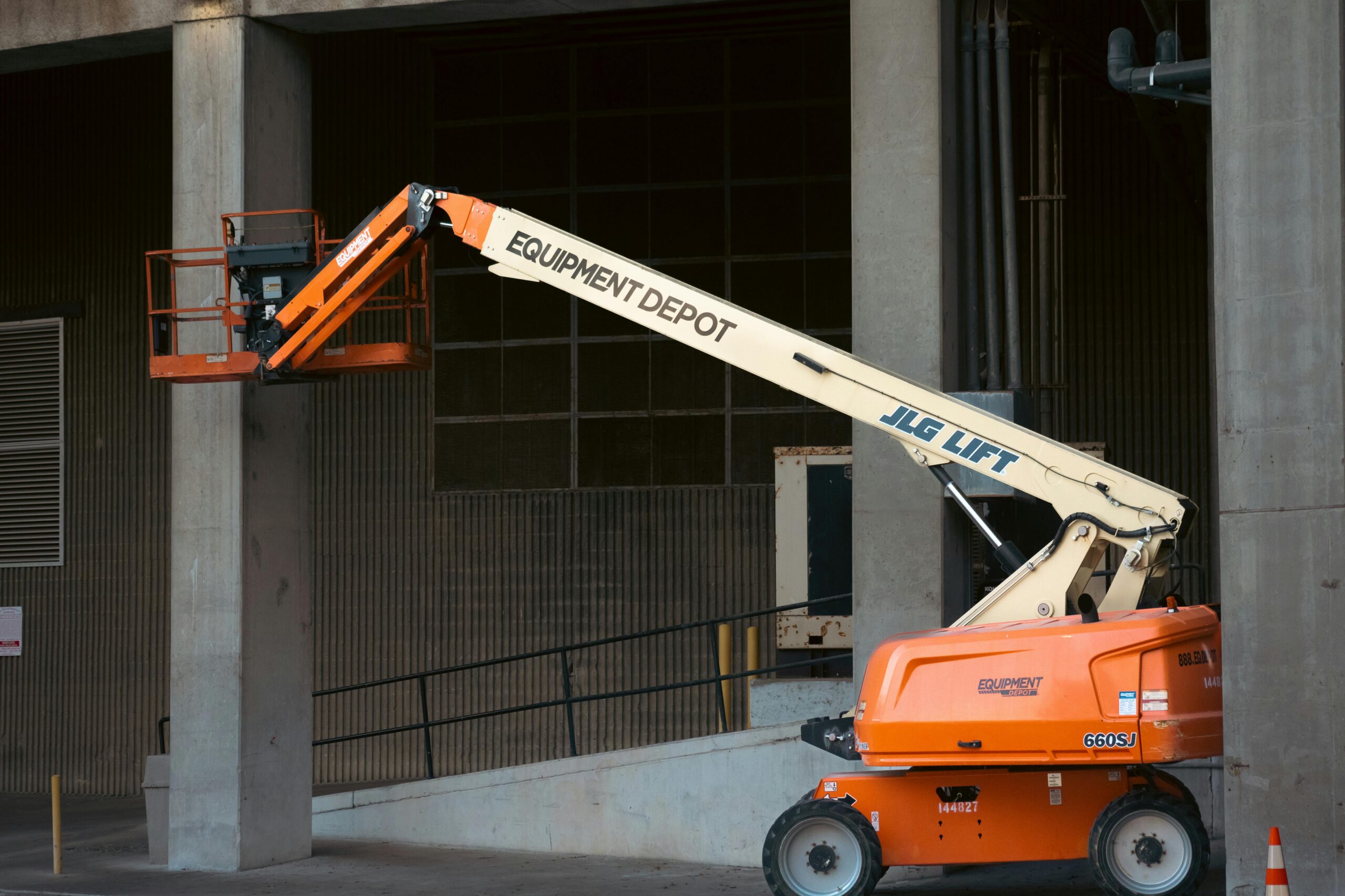 Boom lift in an urban worksite, commonly acquired through financing for heavy equipment