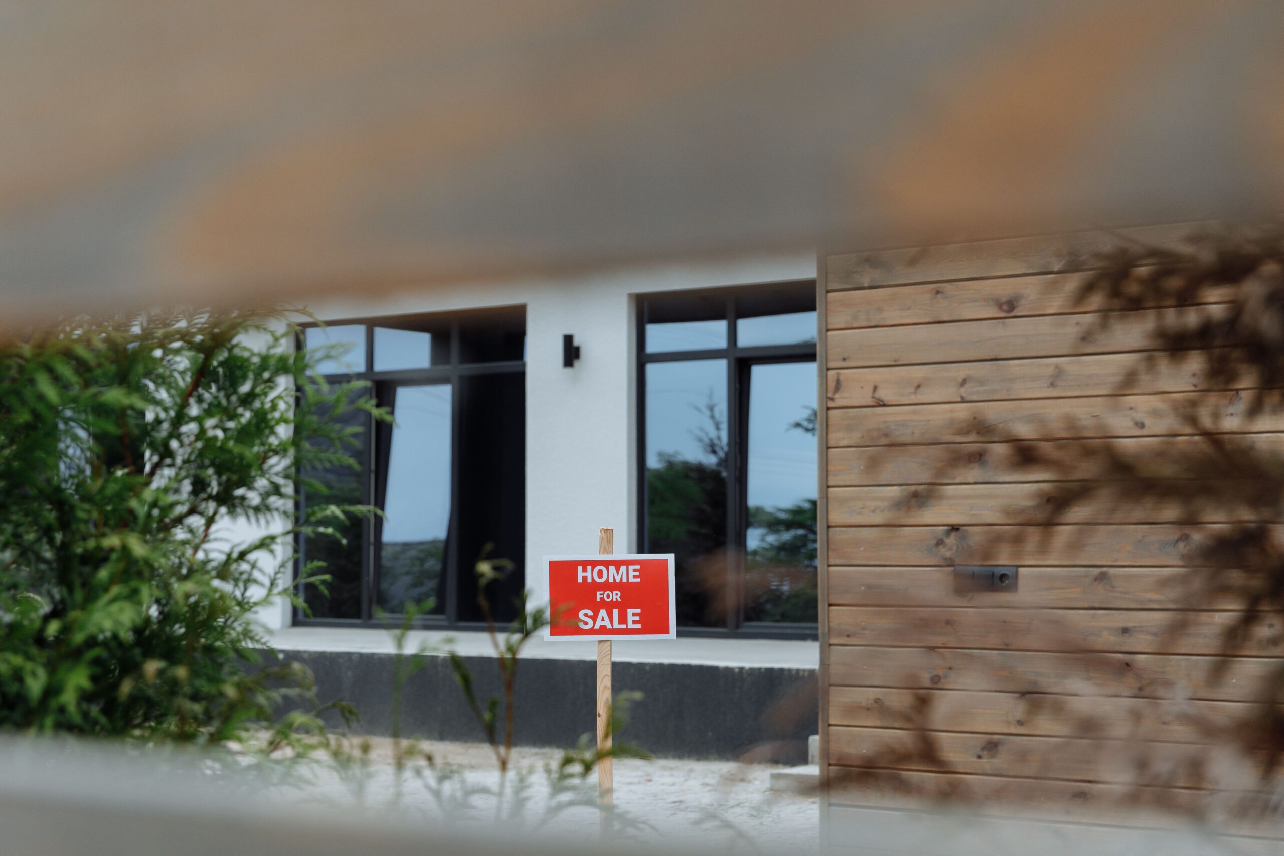 Home for sale with a sign in front, representing a seller financing real estate opportunity.